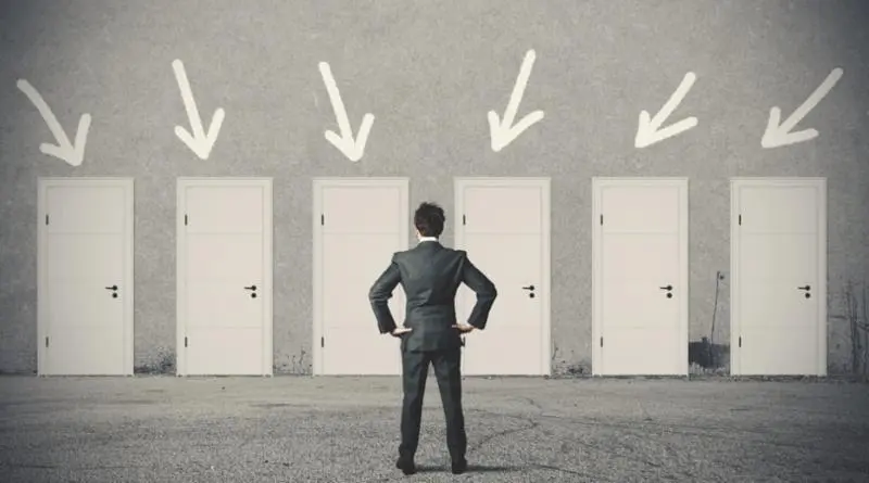 man in suit looks at doors